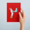 Punainen postikortti, jossa on piirretty kani